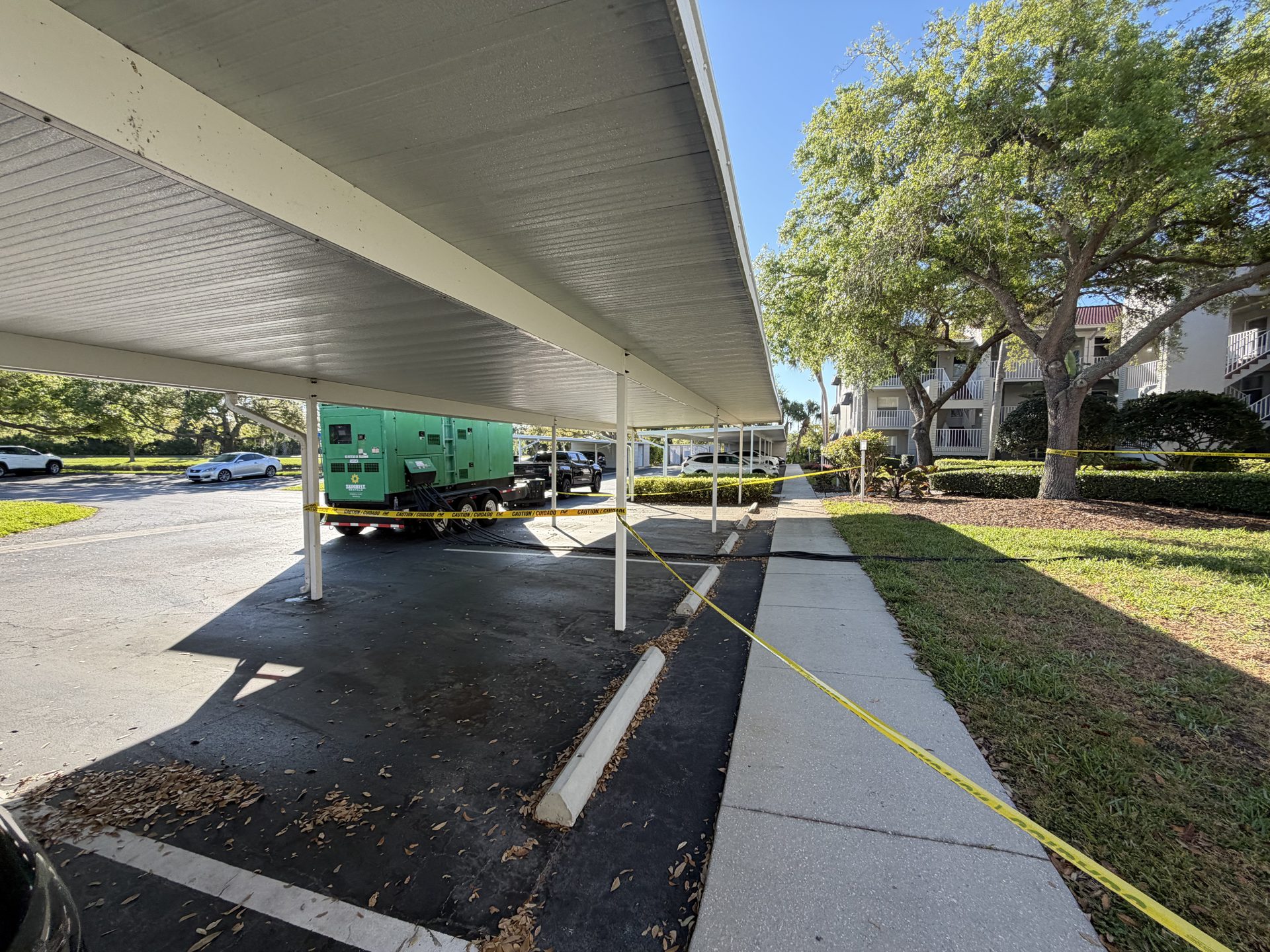 Temporary generator under a carport during condominium power restoration in Sarasota