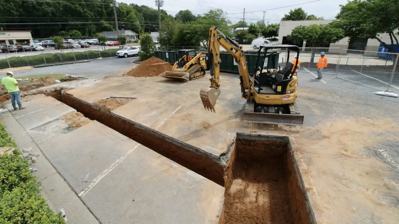Trenching a commercial parking lot for EV charging station feeder conduits
