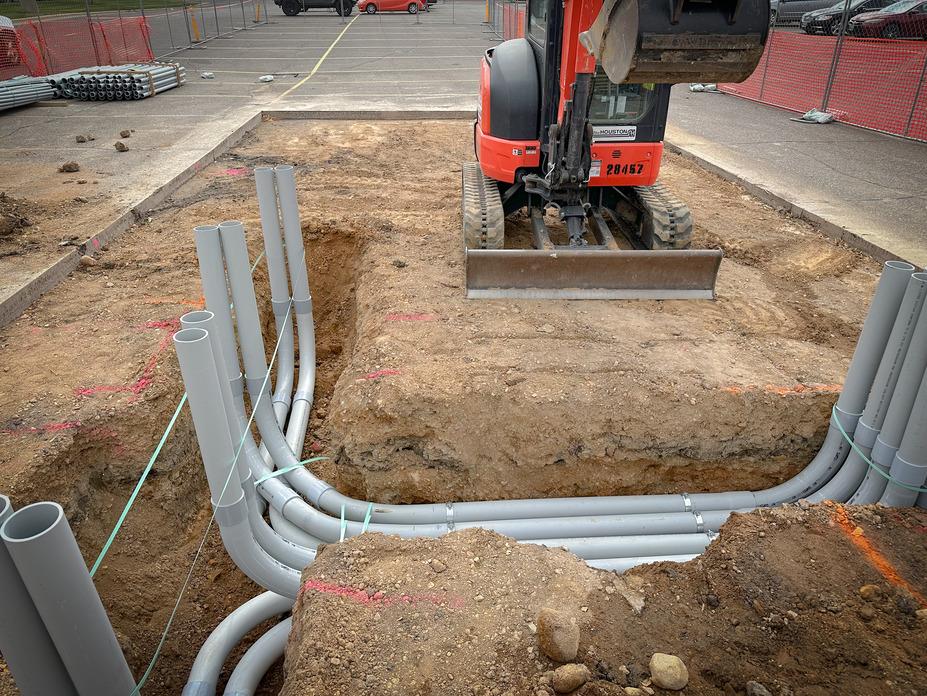 Underground PVC conduit stub-ups for commercial EV charging stations during installation