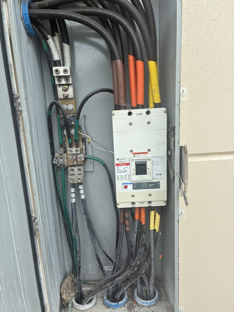 Main breaker and service conductors in a commercial switchboard